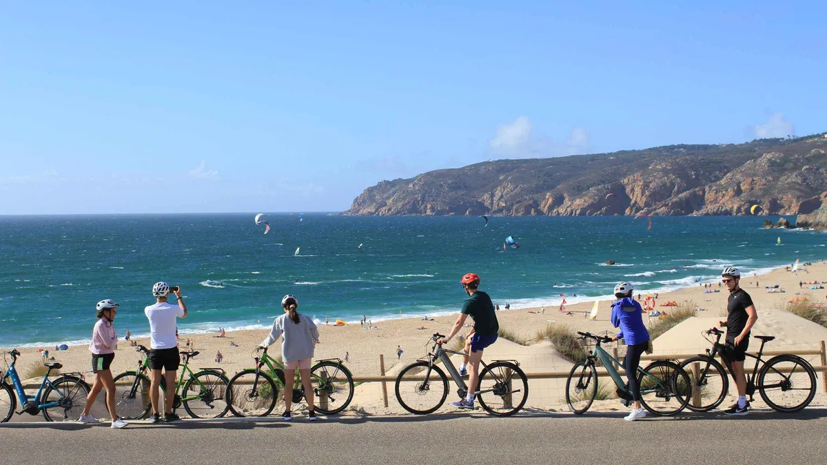 Cyclists riding electric bikes through Sintra-Cascais Natural Park forest trails on a Sintra e-bike tour