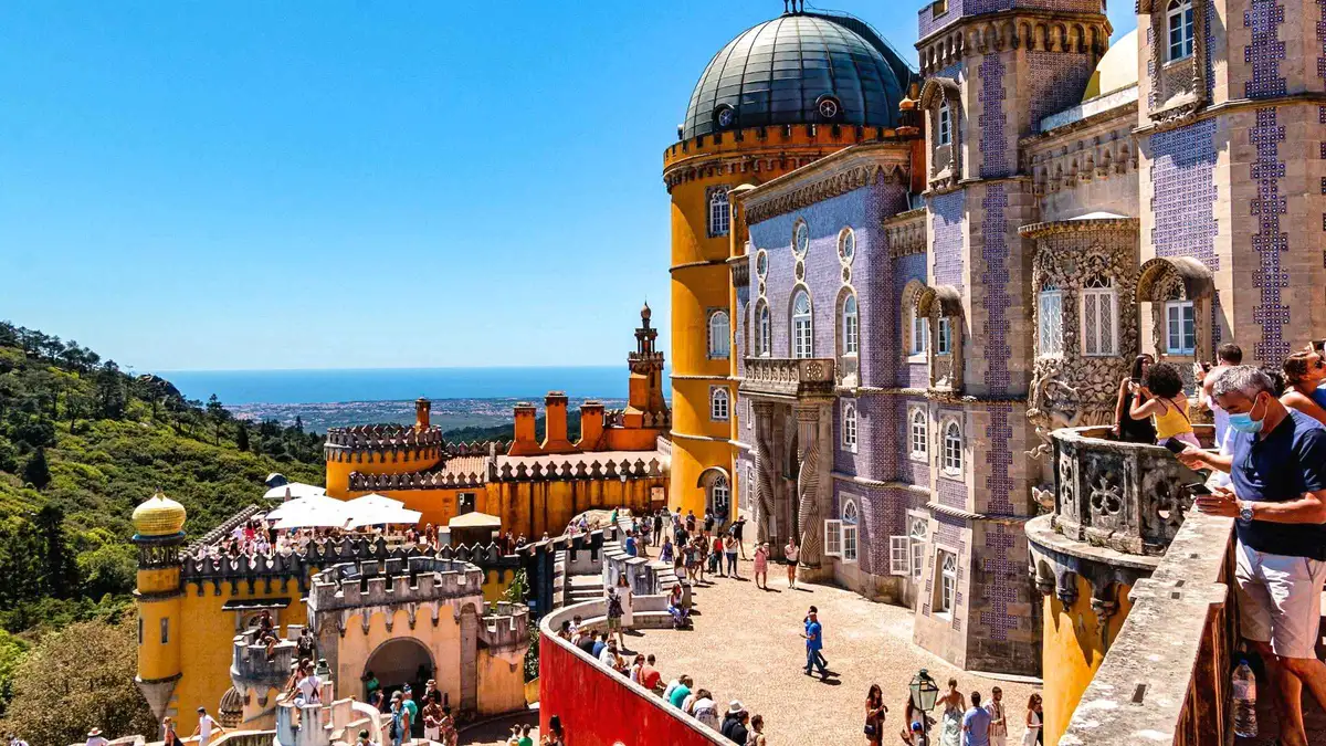 Guide and group at the ramparts of Pena Palace on a Lisbon to Sintra day tour with Cabo da Roca and Cascais